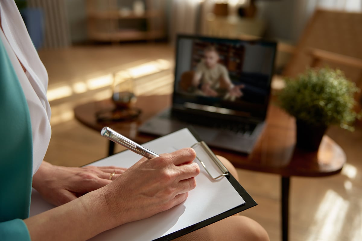 Woman Psychologist Consulting Soldier Online Holding Virtual  on Laptop